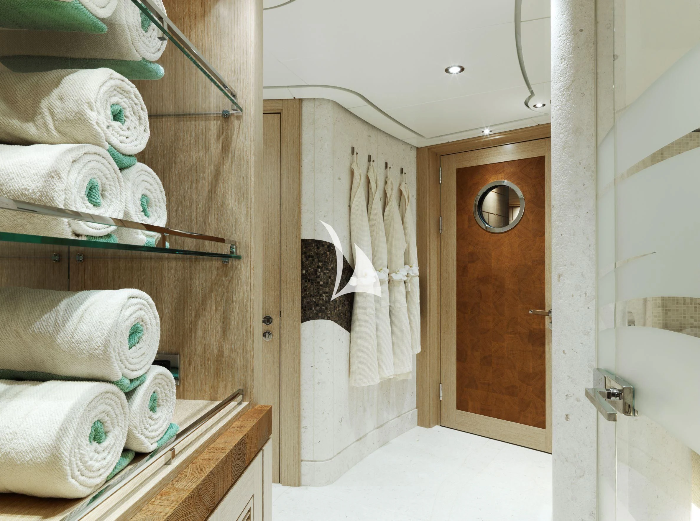 a bathroom with a mirror and a shelf with towels aboard DRAAK Yacht for Sale