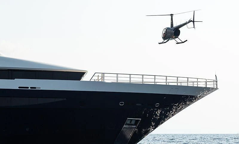a helicopter flying over a ship aboard DRAAK Yacht for Sale