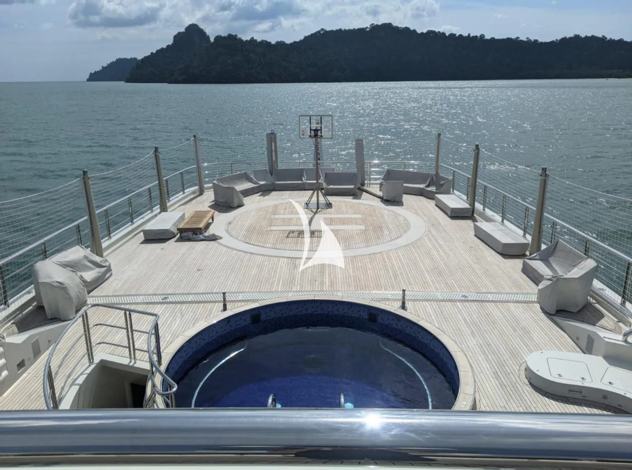 a pool with a deck overlooking a body of water aboard DRAAK Yacht for Sale