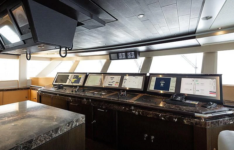 a room with computers and monitors aboard DRAAK Yacht for Sale