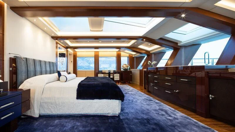 a bedroom with a large bed aboard DRAAK Yacht for Sale