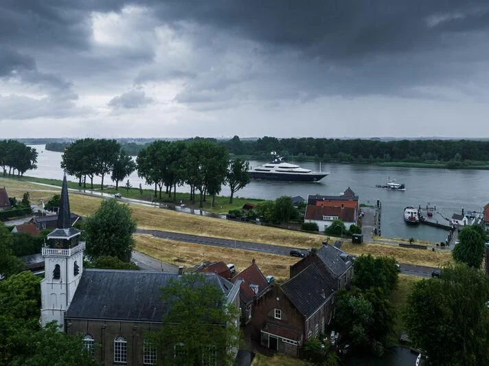 a body of water with boats and buildings along it aboard DRAAK Yacht for Sale