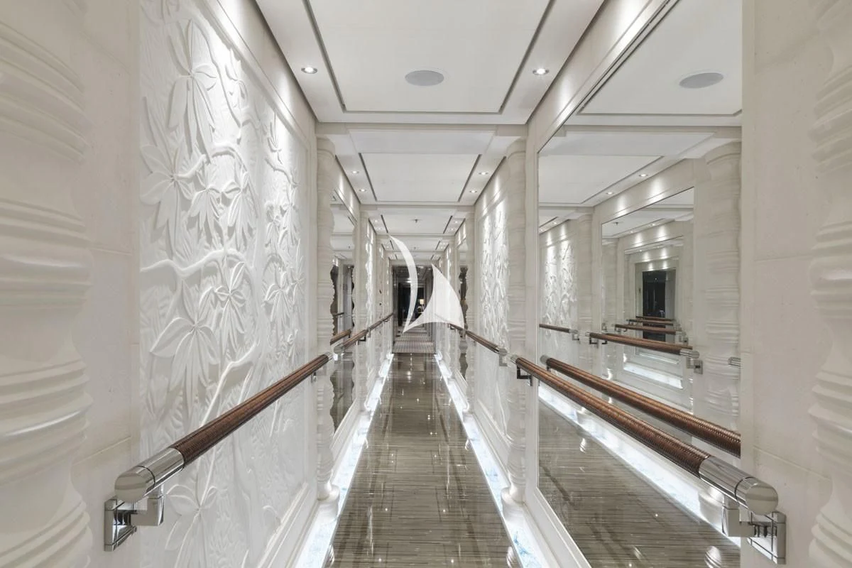 a long hallway with white walls aboard DRAAK Yacht for Sale