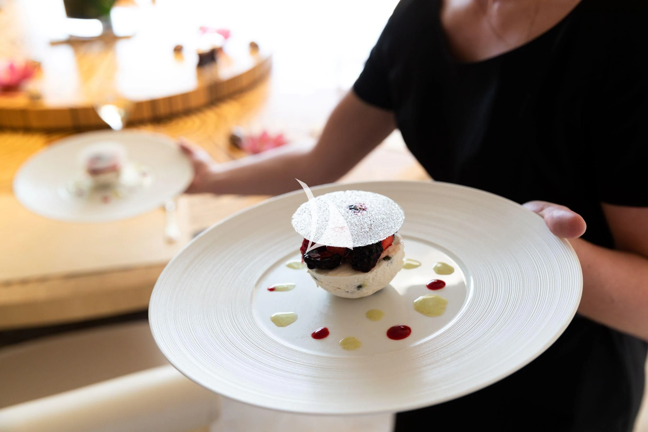 a person holding a plate with food on it aboard DRAAK Yacht for Sale