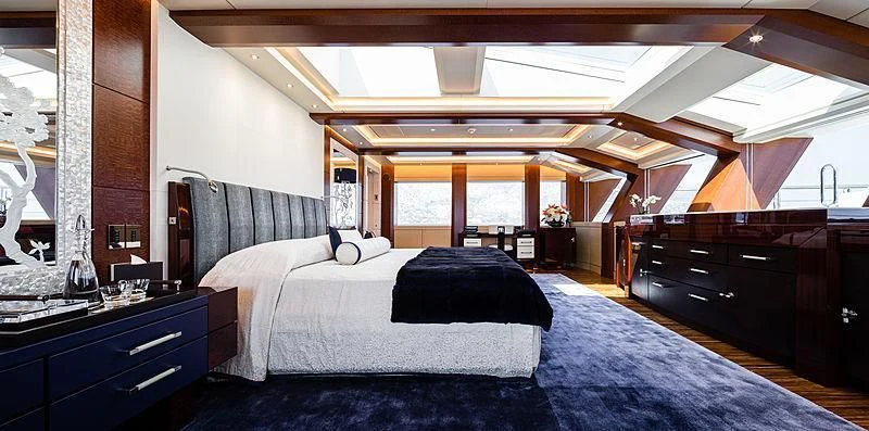 a room with a bed and a desk aboard DRAAK Yacht for Sale