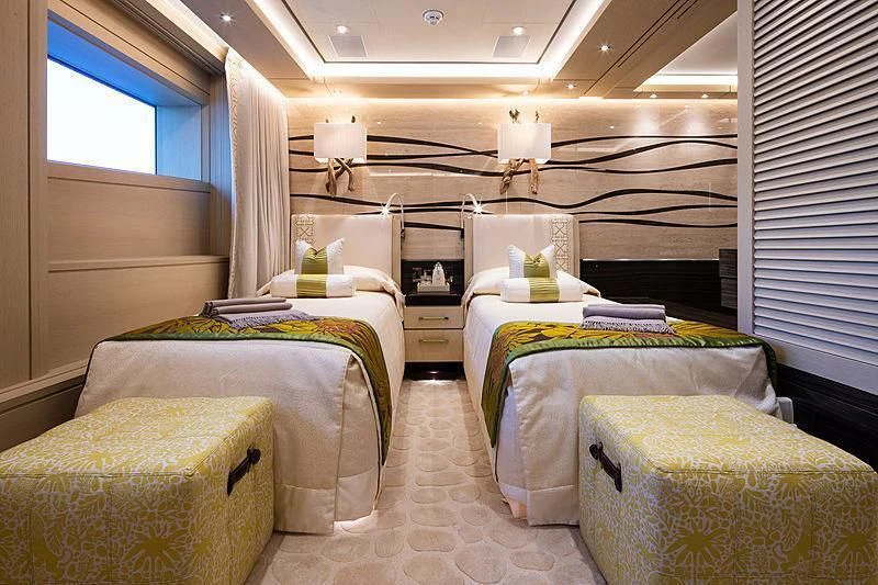 a room with beds and a window aboard DRAAK Yacht for Sale