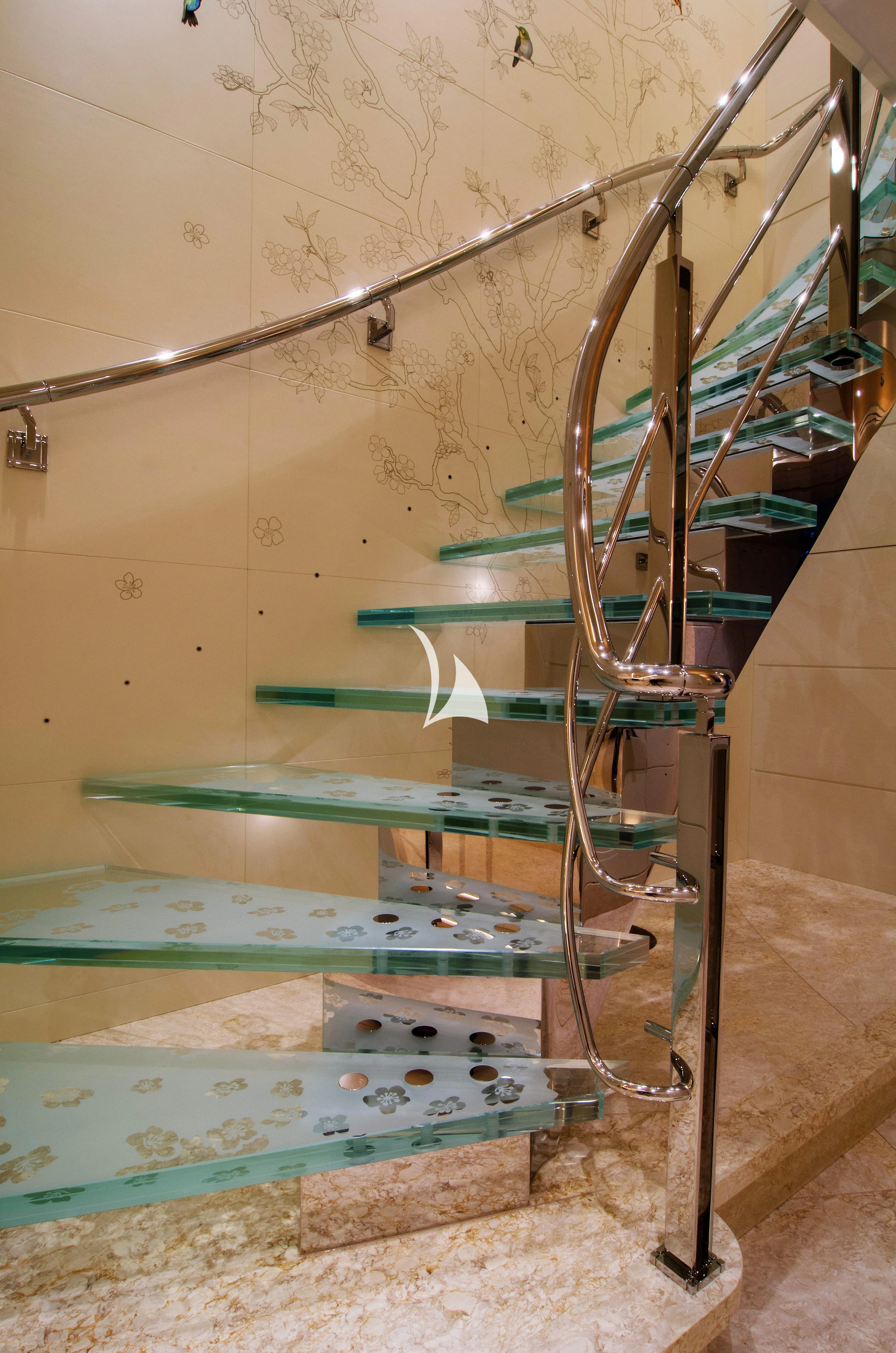 a set of stairs with a spiral staircase and a pool table aboard DRAAK Yacht for Sale