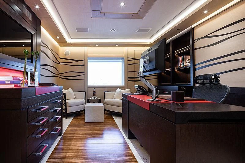 a room with a desk and a tv aboard DRAAK Yacht for Sale
