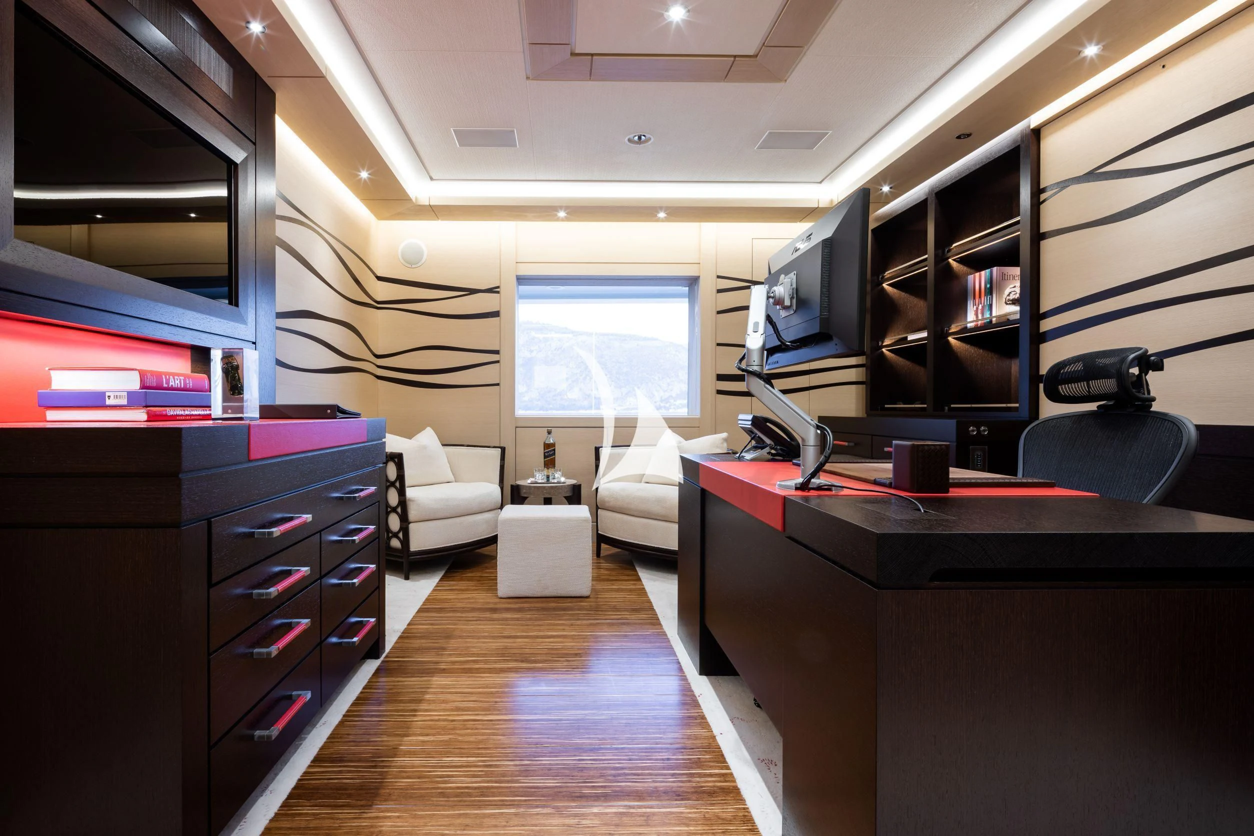 a room with a desk and a bed aboard DRAAK Yacht for Sale