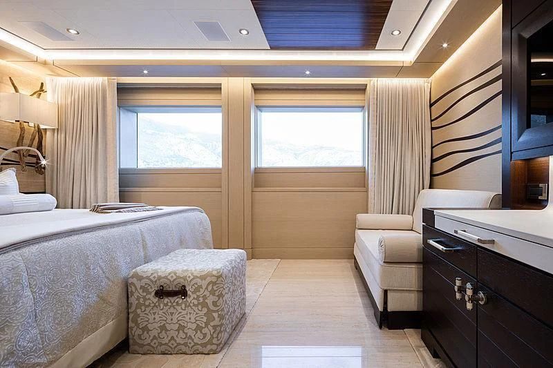 a room with a bed and a chair aboard DRAAK Yacht for Sale