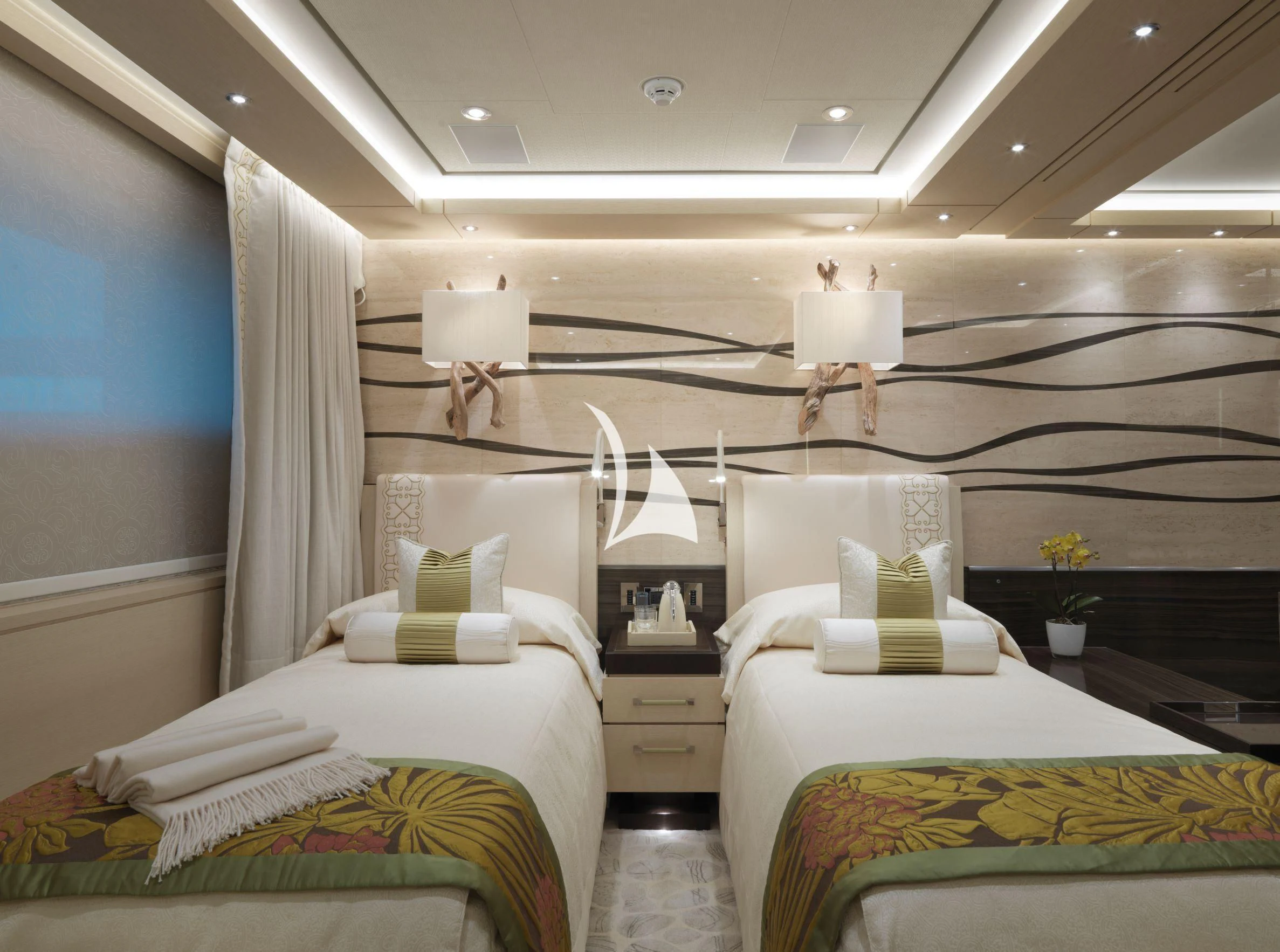 a room with beds and a lamp aboard DRAAK Yacht for Sale
