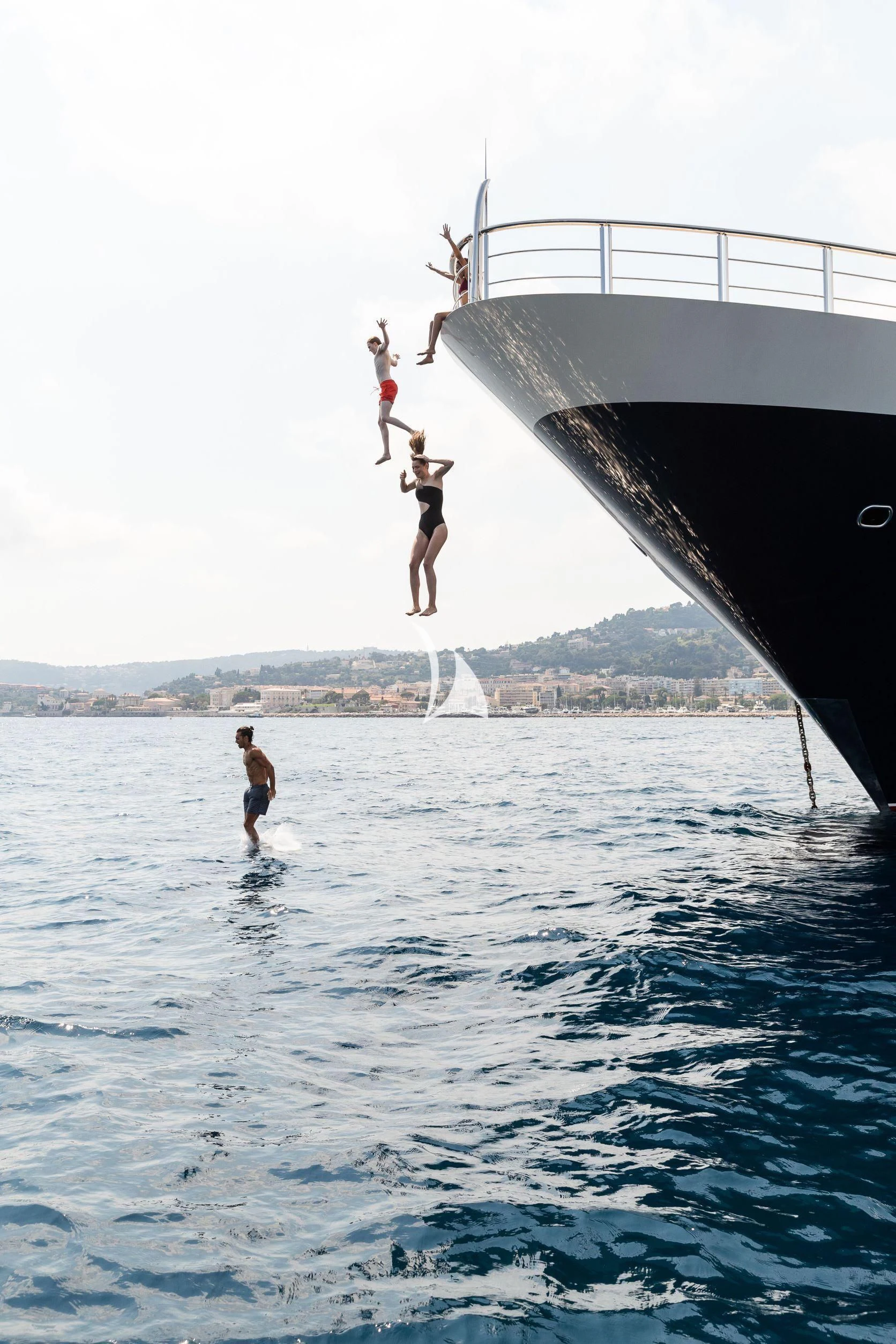 a group of people jumping off a boat aboard DRAAK Yacht for Sale