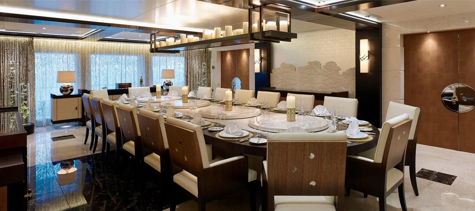 a large dining room with tables and chairs aboard DRAAK Yacht for Sale