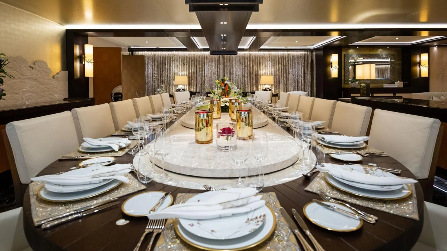 a table with plates and chairs aboard DRAAK Yacht for Sale
