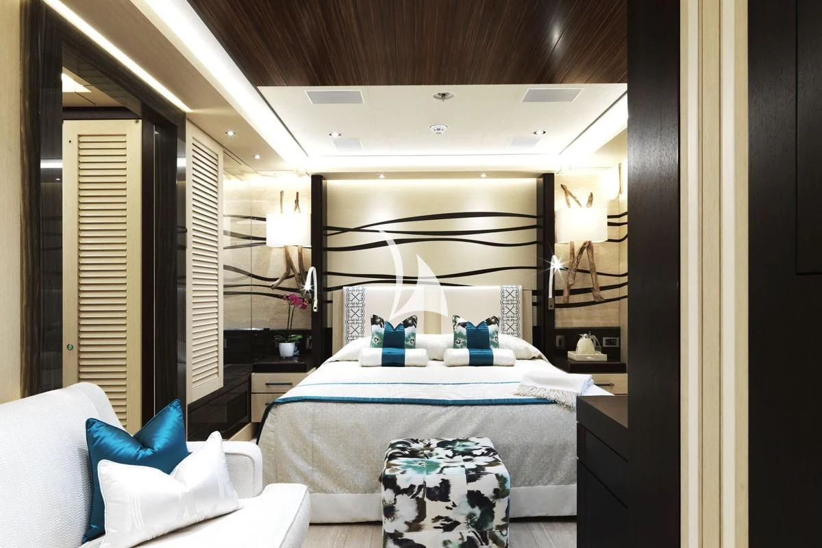 a bedroom with a bed and a mirror aboard DRAAK Yacht for Sale