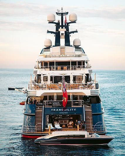 a large ship in the water with Thomas Point Shoal Light in the background aboard DRAAK Yacht for Sale