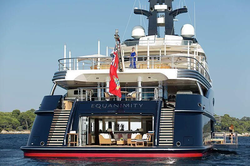 a large boat with a flag on it aboard DRAAK Yacht for Sale