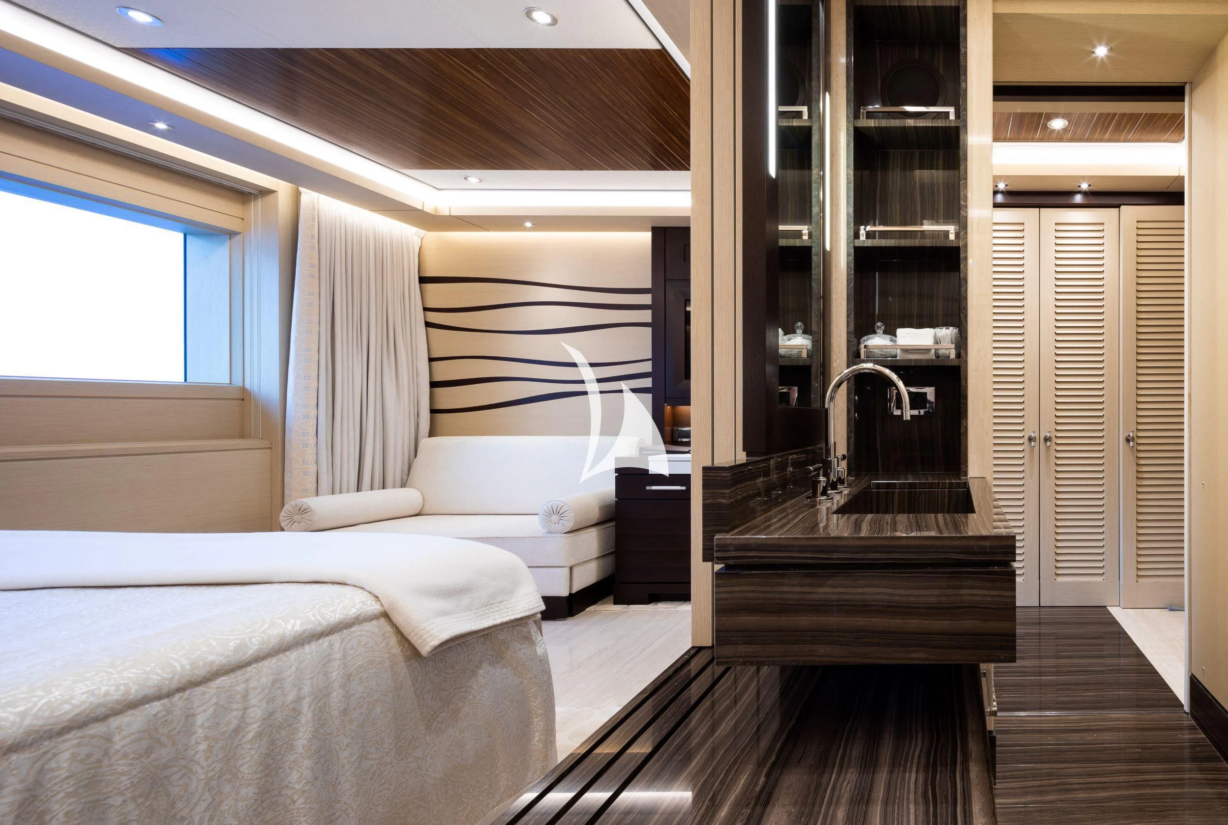 a room with a bed and a mirror aboard DRAAK Yacht for Sale