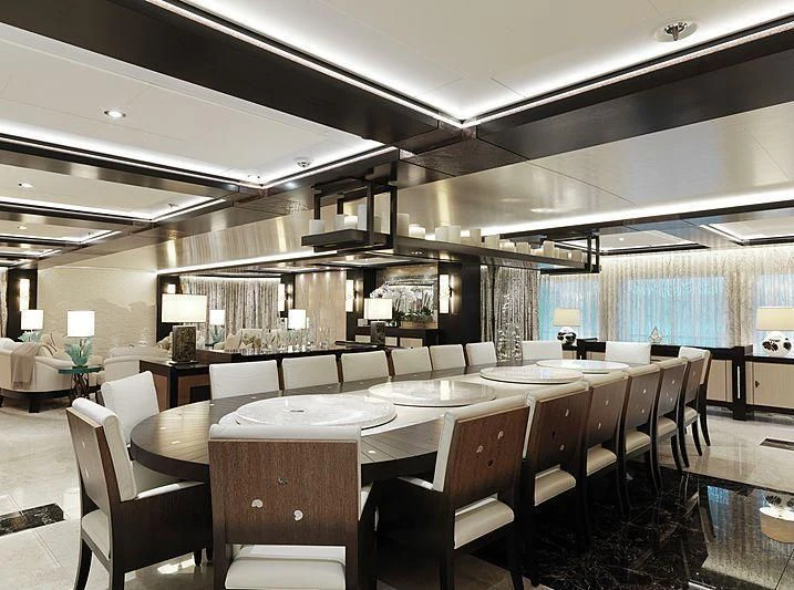 a room with tables and chairs aboard DRAAK Yacht for Sale
