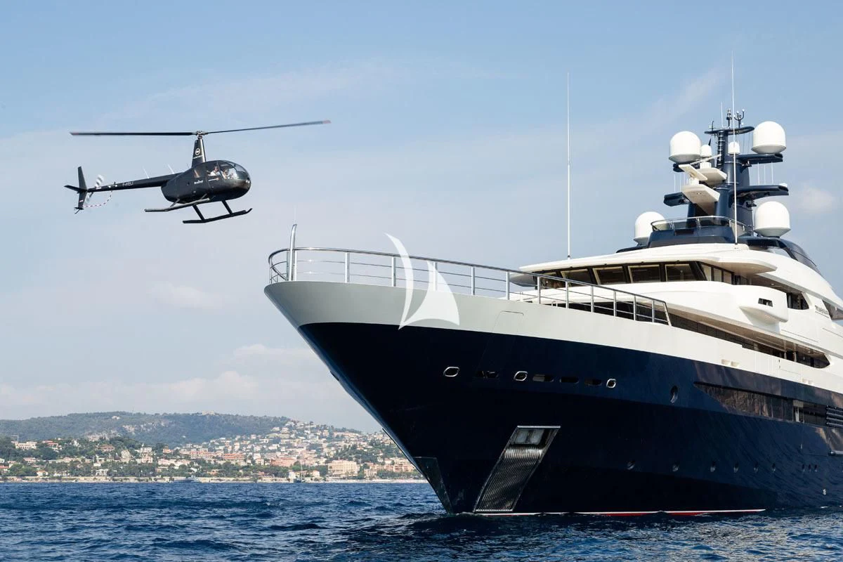 a helicopter flying over a boat aboard DRAAK Yacht for Sale