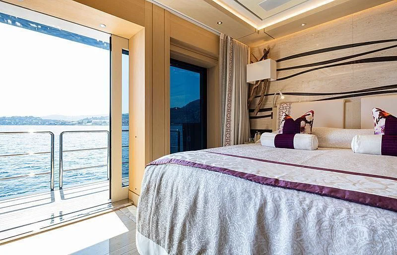 a bedroom with a large bed aboard DRAAK Yacht for Sale