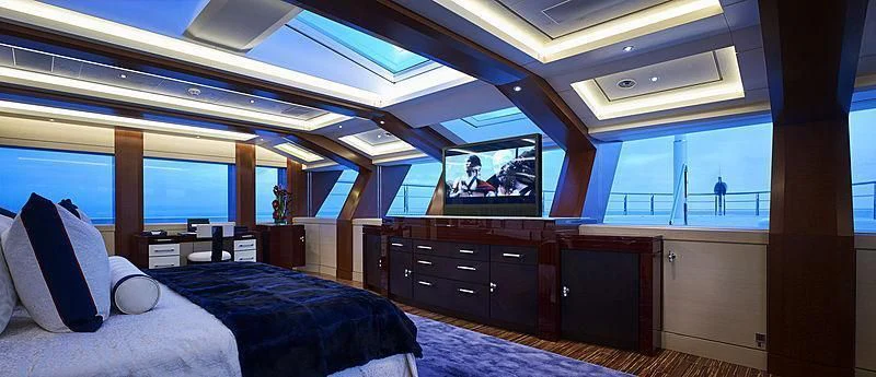 a room with a bed and a tv aboard DRAAK Yacht for Sale
