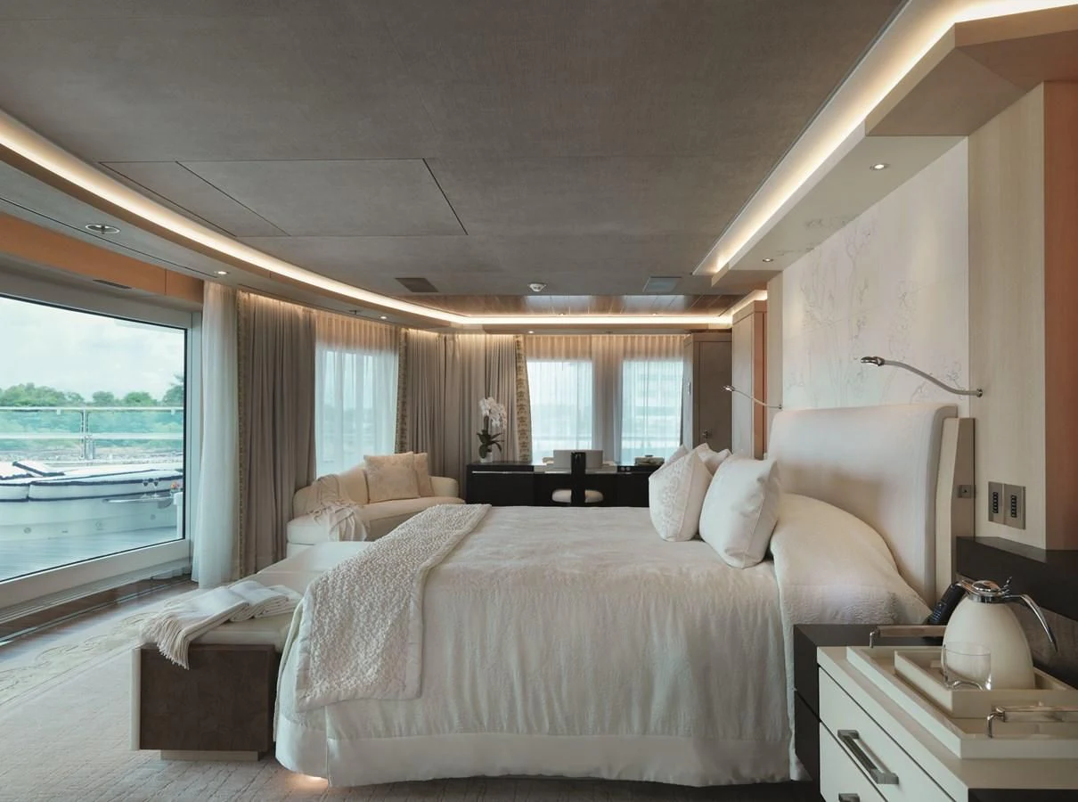 a bedroom with a large bed aboard DRAAK Yacht for Sale