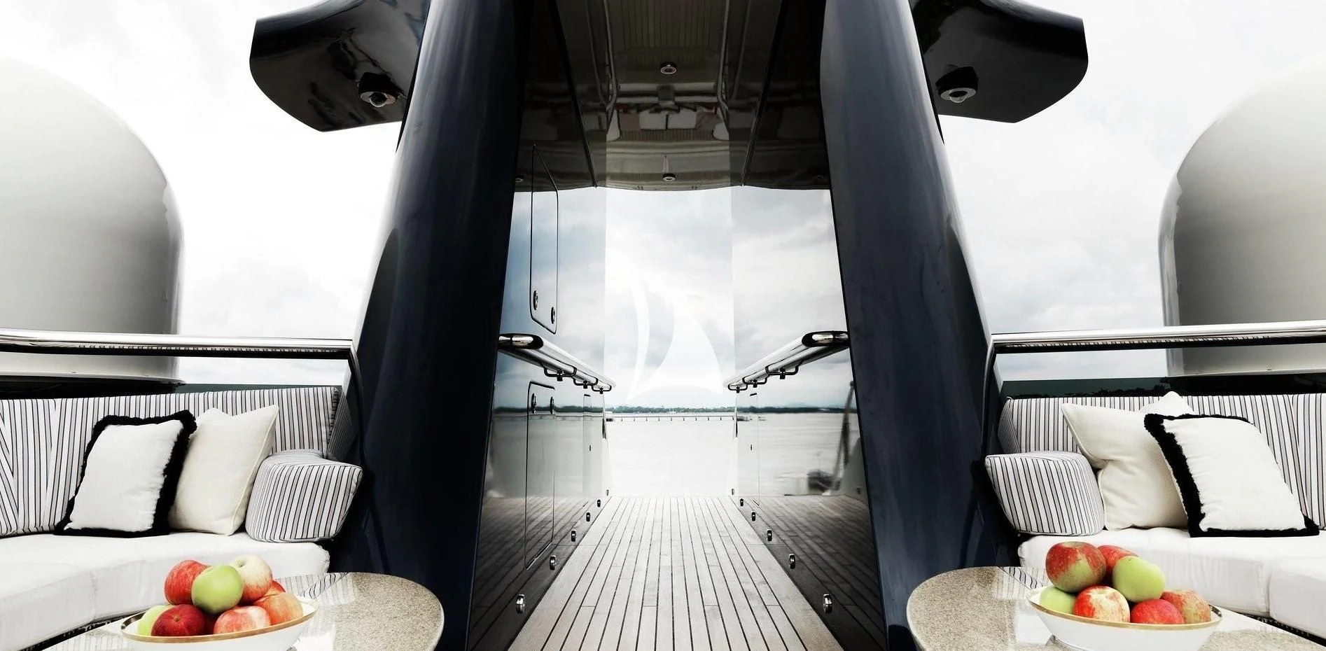 a room with a bed and a table with fruit on it aboard DRAAK Yacht for Sale