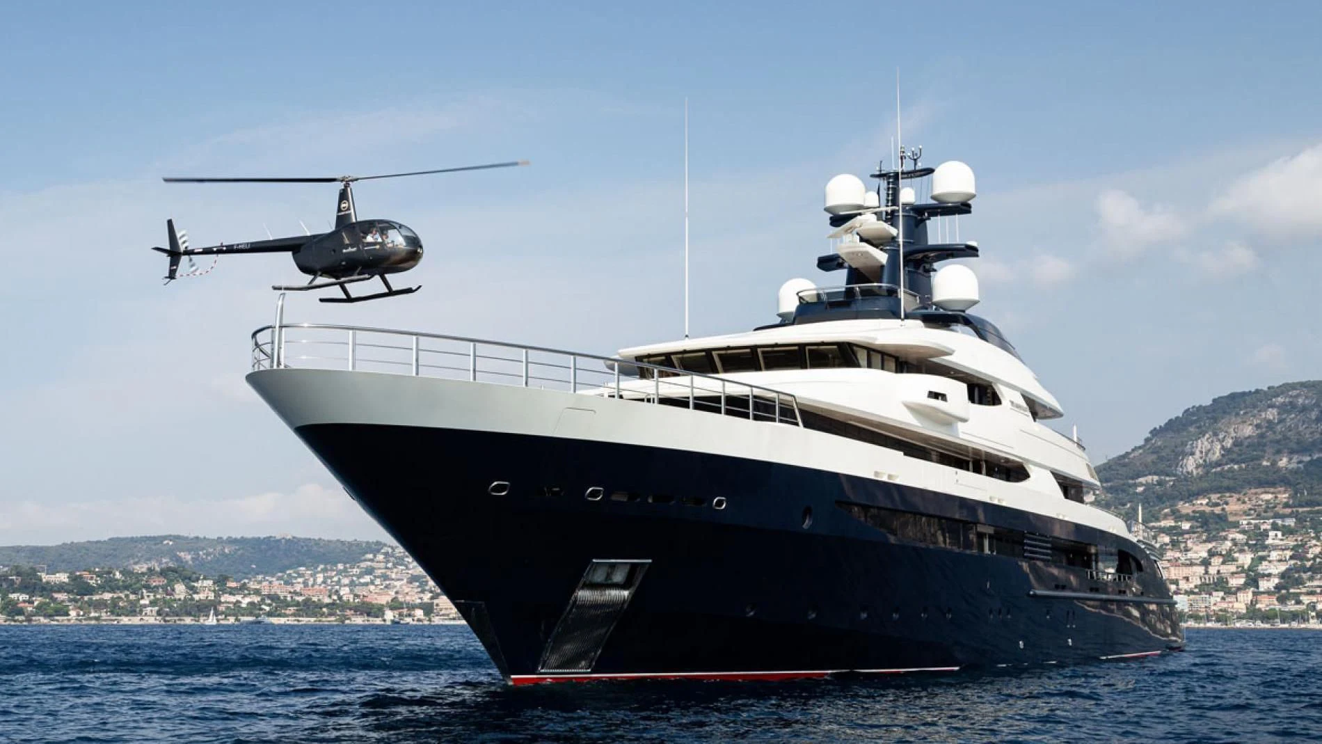 a helicopter flying over a ship aboard DRAAK Yacht for Sale