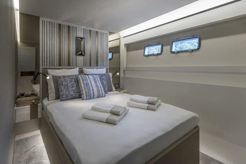 a bed with a white bed spread aboard LADY STEFANI Yacht for Sale