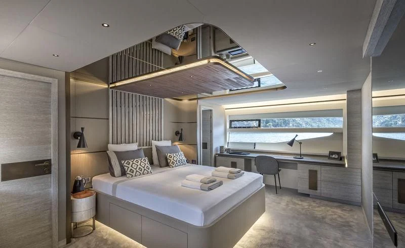 a large bedroom with a large balcony aboard LADY STEFANI Yacht for Sale