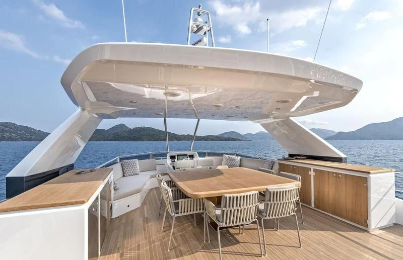a large ship with a table and chairs on a deck aboard LADY STEFANI Yacht for Sale