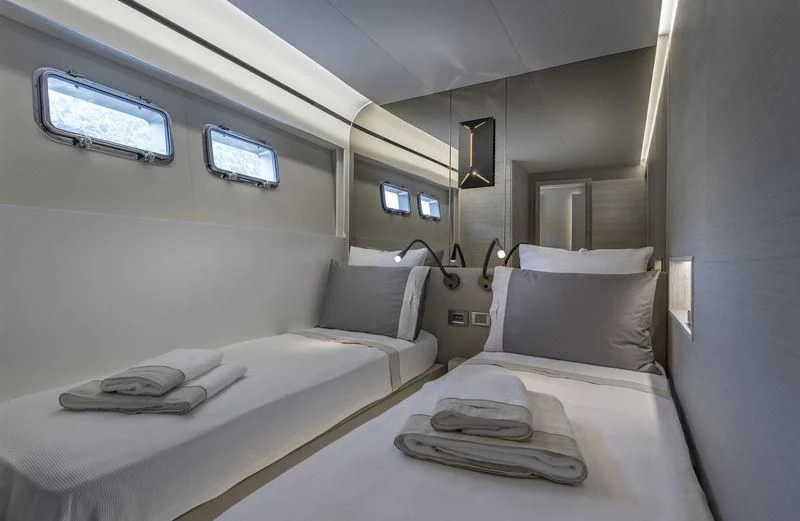 a bed with a white sheet and pillows on it aboard LADY STEFANI Yacht for Sale