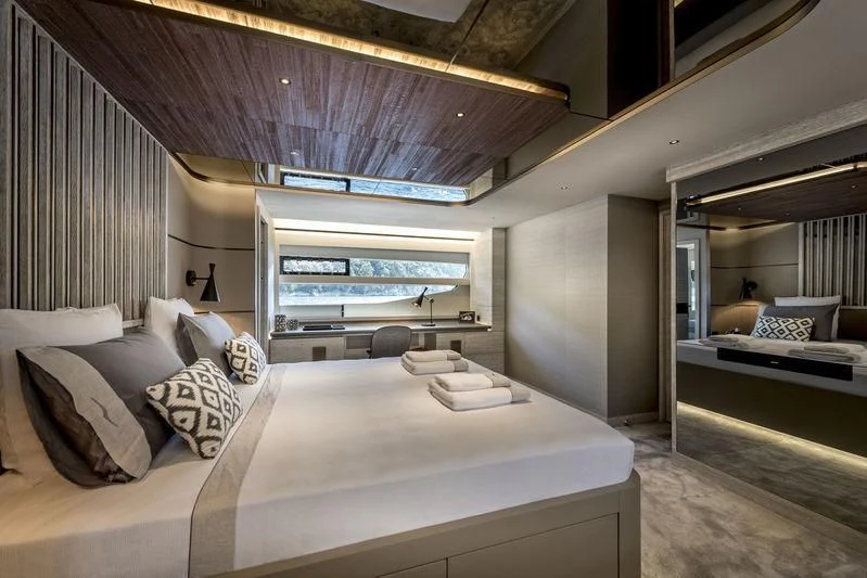 a bedroom with a bed and a large bed aboard LADY STEFANI Yacht for Sale