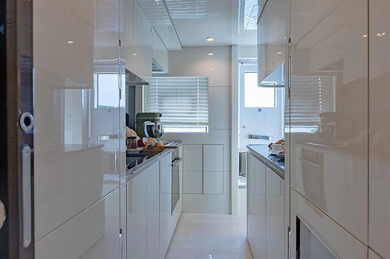 a kitchen with white cabinets aboard MANIKIM Yacht for Sale