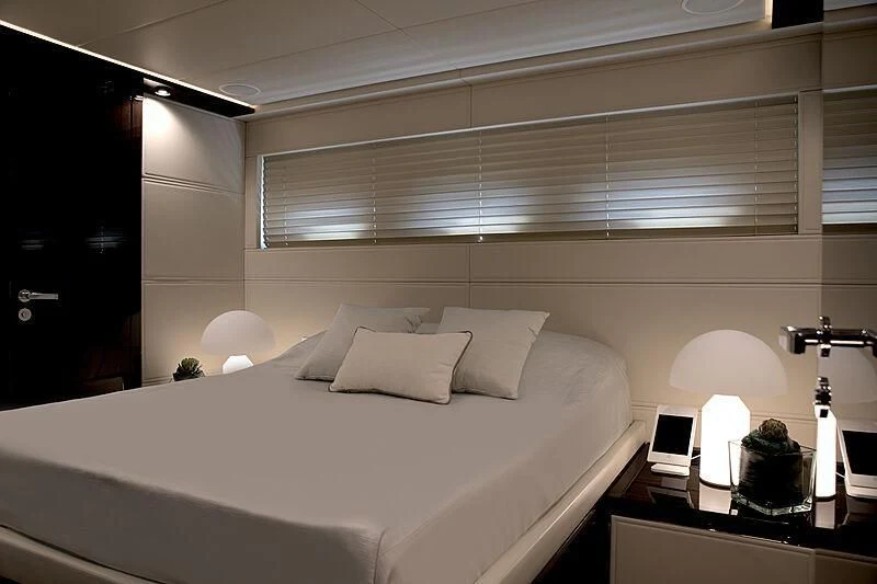 a bed with a white sheet and a white bed spread aboard MANIKIM Yacht for Sale