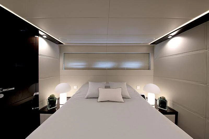 a bed with white sheets and pillows aboard MANIKIM Yacht for Sale