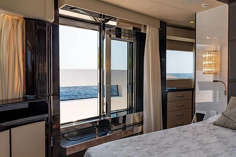 a bedroom with a large window aboard MANIKIM Yacht for Sale