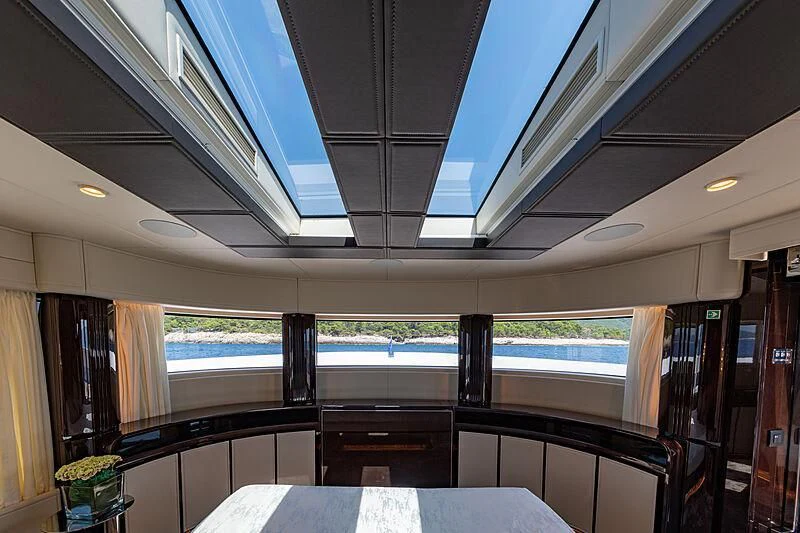 inside of a building with a large ceiling and a table with chairs aboard MANIKIM Yacht for Sale