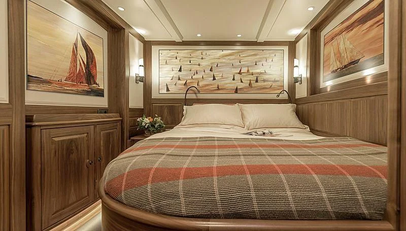 a bed with a red and white checkered blanket aboard SVEA Yacht for Sale