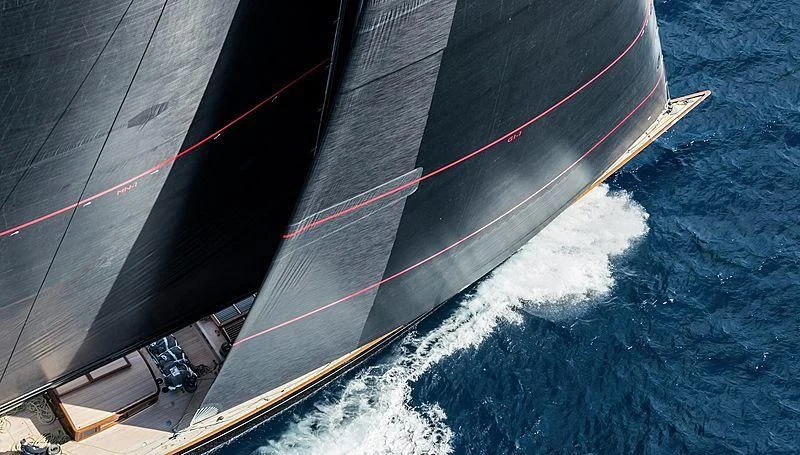 a red and white ship sailing on the sea aboard SVEA Yacht for Sale
