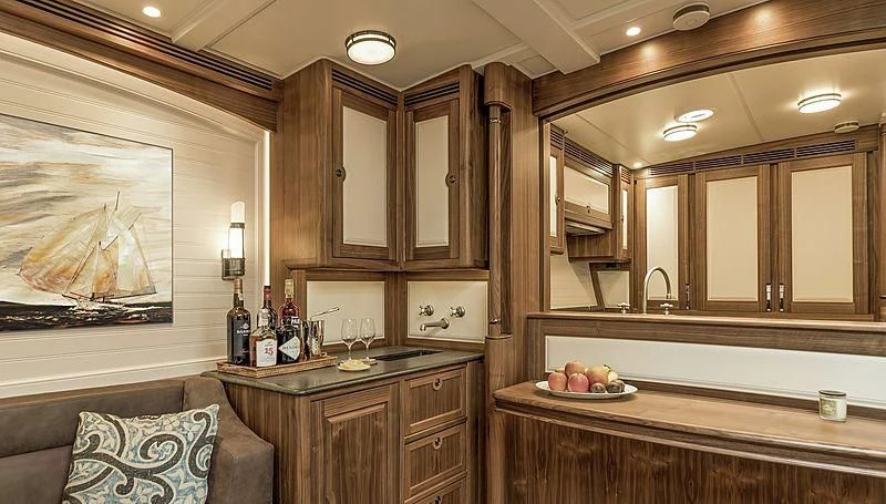 a kitchen with wooden cabinets aboard SVEA Yacht for Sale