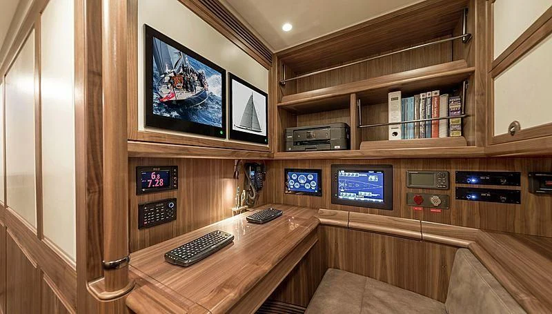 a room with a desk and a tv aboard SVEA Yacht for Sale