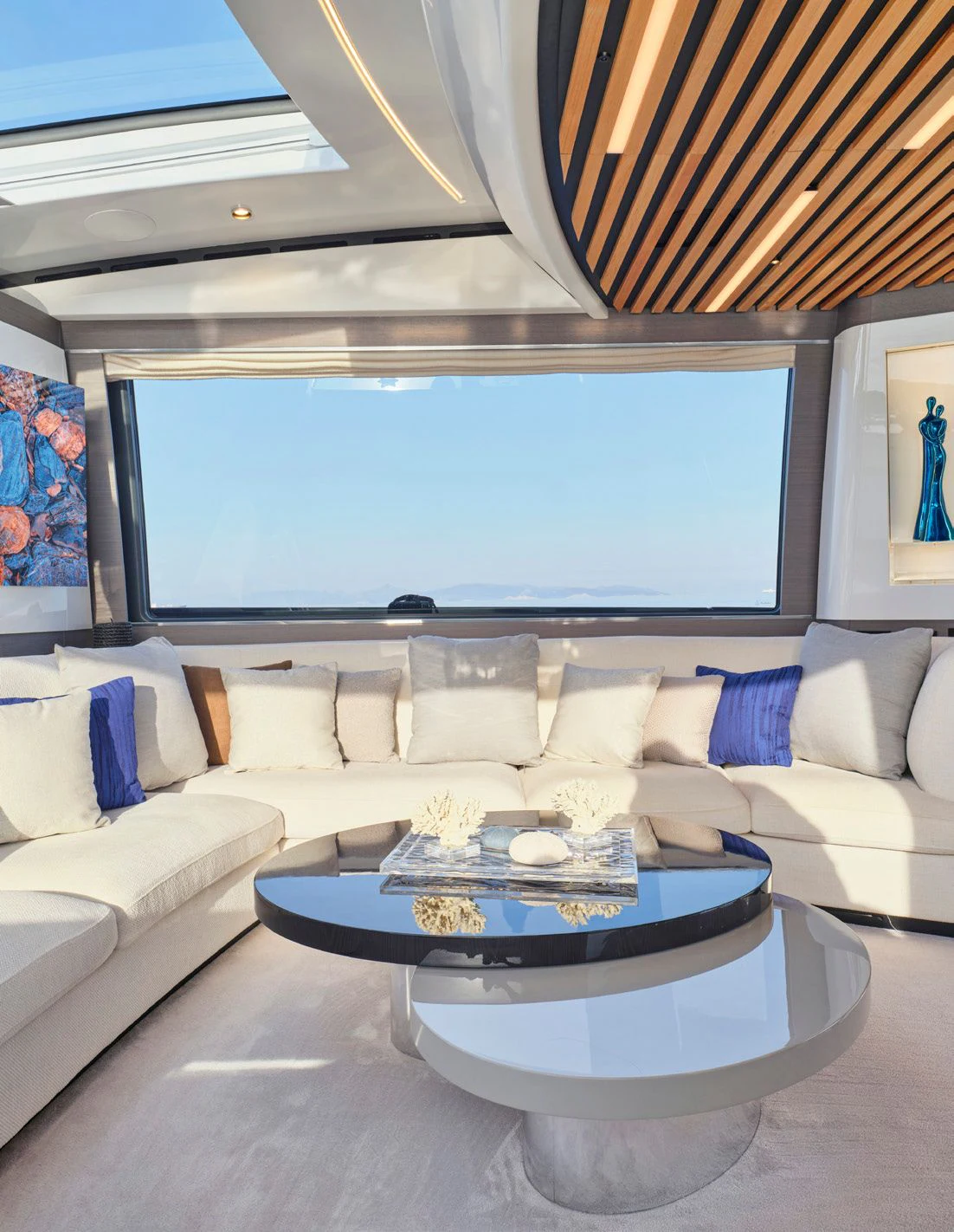 a living room with a large round table and a large window aboard D FIVE Yacht for Sale