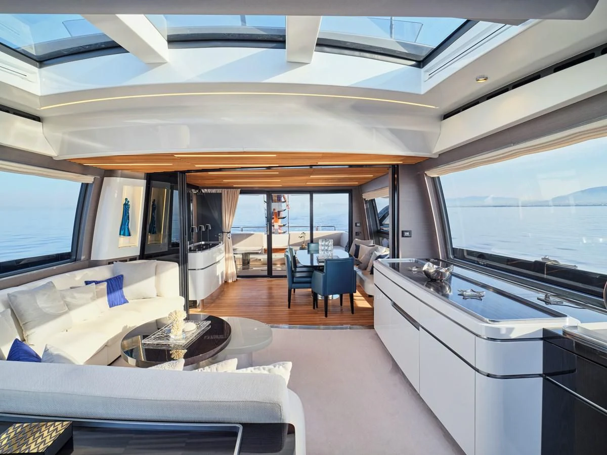 a room with a large window and a table with chairs and a tv aboard D FIVE Yacht for Sale