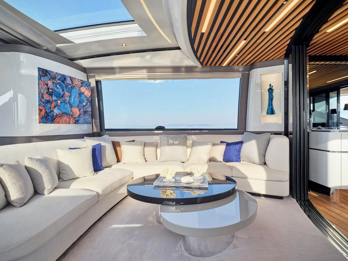 a living room with a large white sofa and a large window aboard D FIVE Yacht for Sale