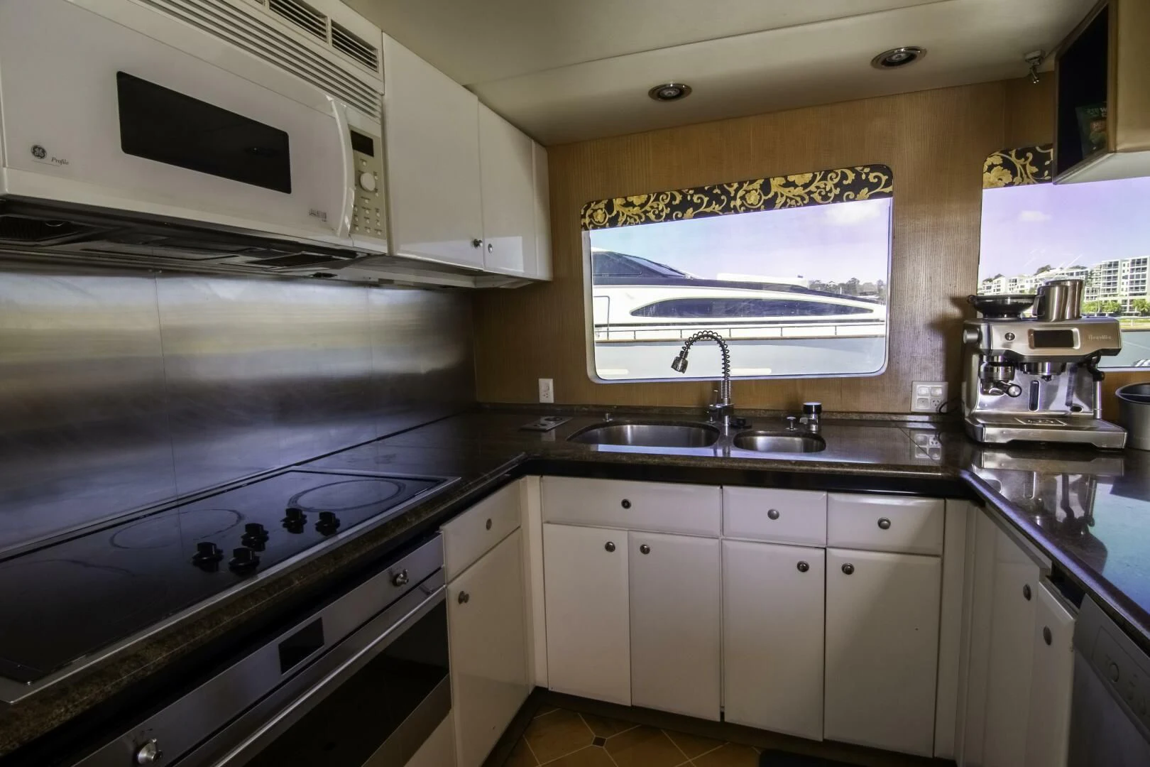 a kitchen with white cabinets aboard LADY AUDREY Yacht for Sale