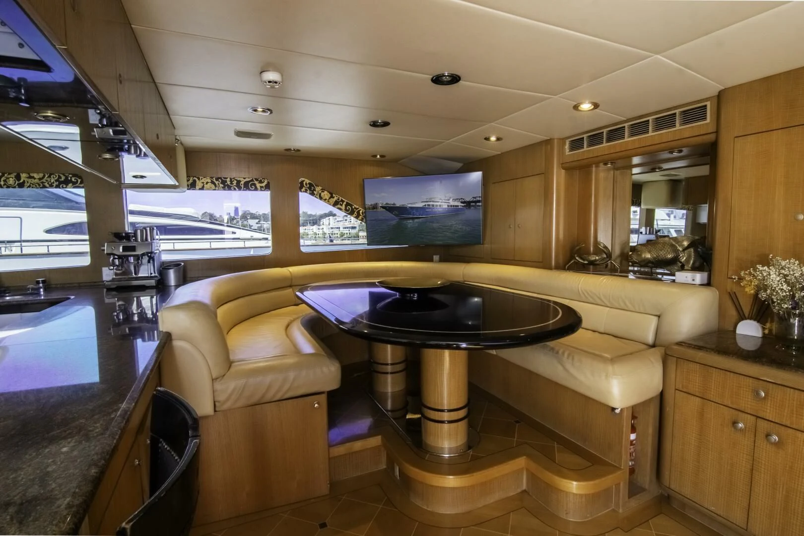 a kitchen with a bar and a table aboard LADY AUDREY Yacht for Sale
