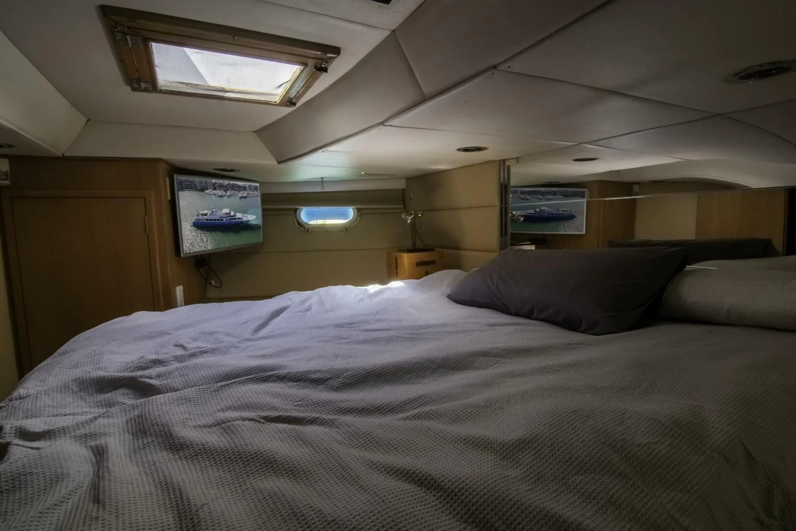 a bed with a white comforter aboard LADY AUDREY Yacht for Sale