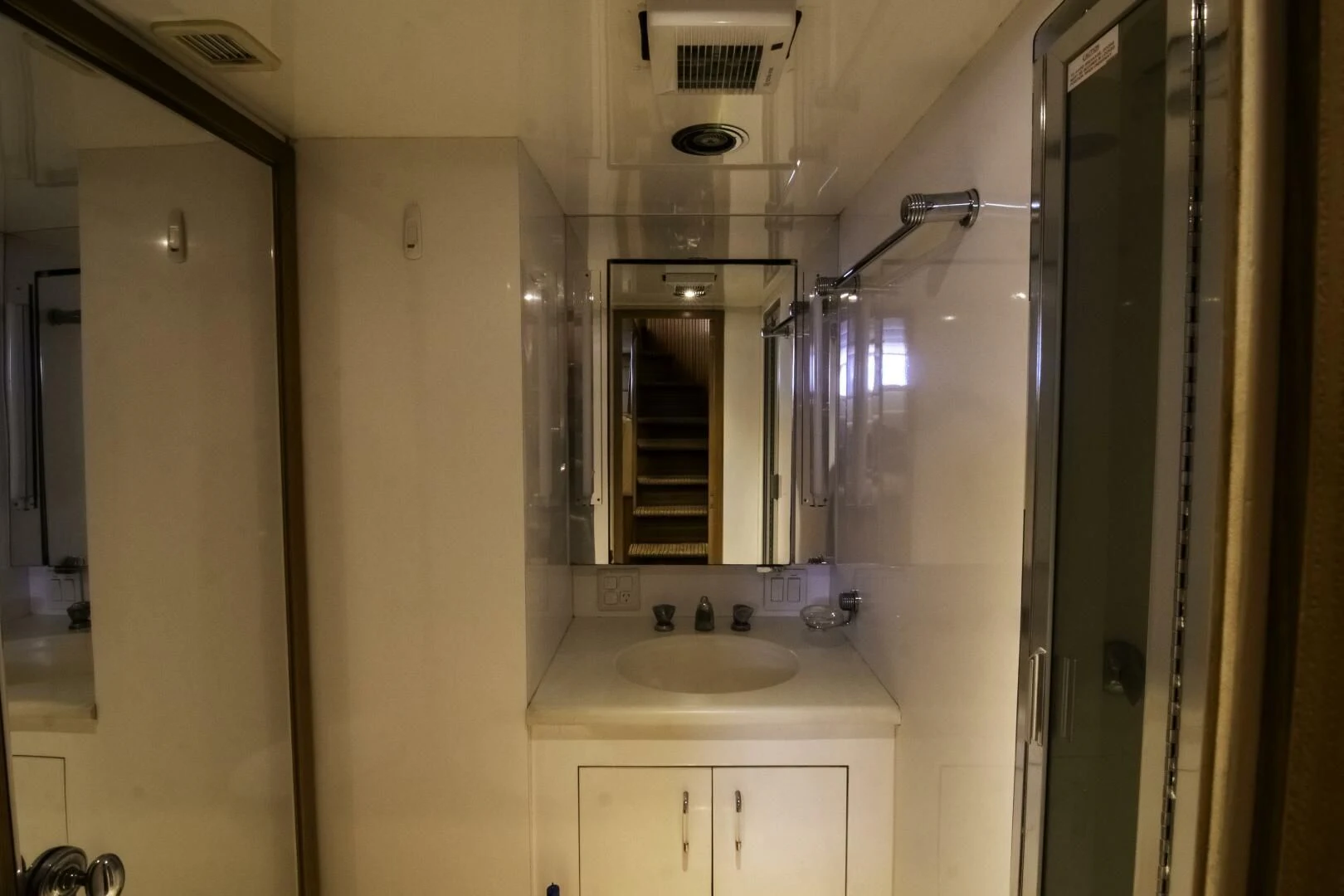 a bathroom with a sink and a mirror aboard LADY AUDREY Yacht for Sale
